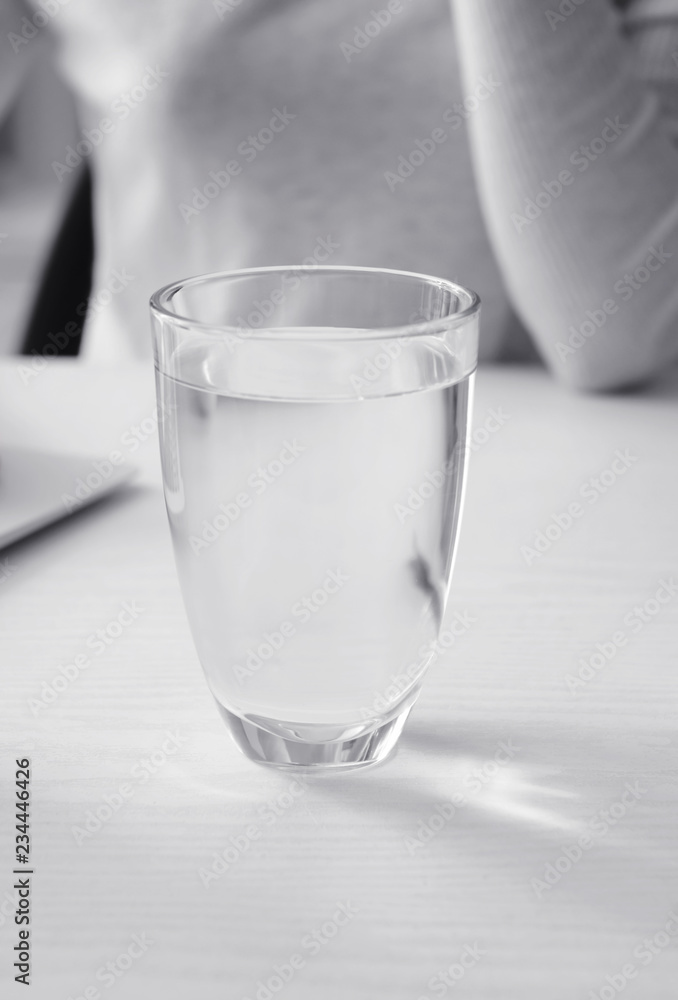 Glass of fresh water on white table
