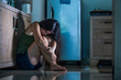 © TheVisualsYouNeed - young  depressed Asian Chinese woman crying scared at home kitchen floor feeling anxious and sad suffering depression and anxiety victim of domestic violence