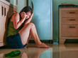 © TheVisualsYouNeed - young scared desperate Asian Japanese woman crying at home kitchen floor suffering domestic violence and sexual abuse victim of drunk alcoholic husband