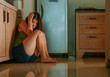© TheVisualsYouNeed - young scared and desperate Asian Japanese woman crying helpless at home kitchen floor suffering domestic violence and sexual abuse victim of jealous drunk husband