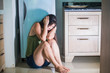 © TheVisualsYouNeed - young scared and desperate Asian Japanese woman crying helpless at home kitchen floor suffering domestic violence and sexual abuse victim of jealous drunk husband