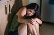 © TheVisualsYouNeed - young scared and desperate Asian Japanese woman crying helpless at home kitchen floor suffering domestic violence and sexual abuse victim of jealous husband