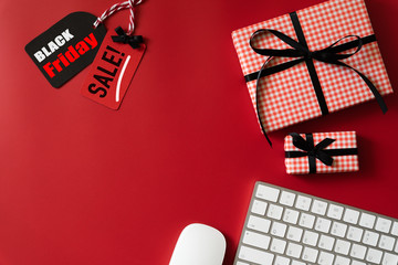 Wall Mural - Black Friday Sale text on a red and black tag with Alarm Clock, keyboard computer and gift box on red background. Shopping concept.