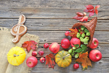 Cornucopia With Apples, Autumn Leaves, Pumpkins , Music Gingerbread On Wooden Background 