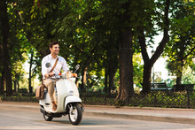 Young Business Man Walking Outdoors On Scooter.