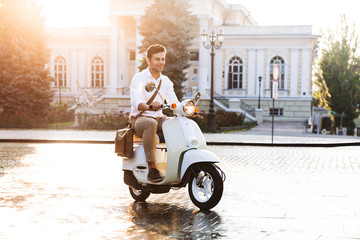 Poster - Young business man walking outdoors on scooter.