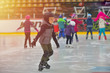 © Daniel CHETRONI - Adorable little boy in winter clothes with protections skating on ice rink