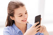 © Syda Productions - children, technology and communication concept - smiling girl messaging on smartphone at home