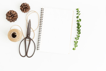 Wall Mural - blank notebook and scissors on white background, top view image of white notebook and empty space fo