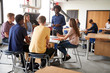 © Monkey Business - Group Of High School Students Sitting At Work Benches Listening To Teacher In Design And Technology Lesson