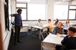 © Monkey Business - Male High School Teacher Standing Next To Interactive Whiteboard And Teaching Lesson