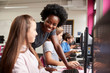 © Monkey Business - Teacher Helping Female Pupil Line Of High School Students Working at Screens In Computer Class