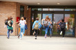 © Monkey Business - Group Of High School Students Running Into School Building At Beginning Of Class