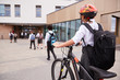© Monkey Business - Group Of High School Students Wearing Uniform Arriving At School Walking Or Riding Bikes