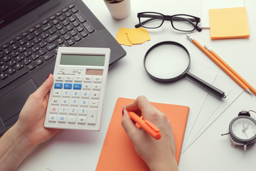 Business woman working with financial data hand using calculator