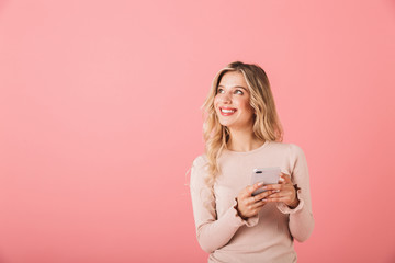 Wall Mural - Portrait of a cheerful young woman wearing sweater