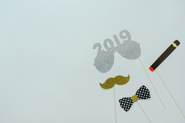 Wall Mural - Table top view of Merry Christmas decorations & Happy new year 2019 ornaments concept.Flat lay essential difference objects to party season the photo booth prob on modern wooden white background.