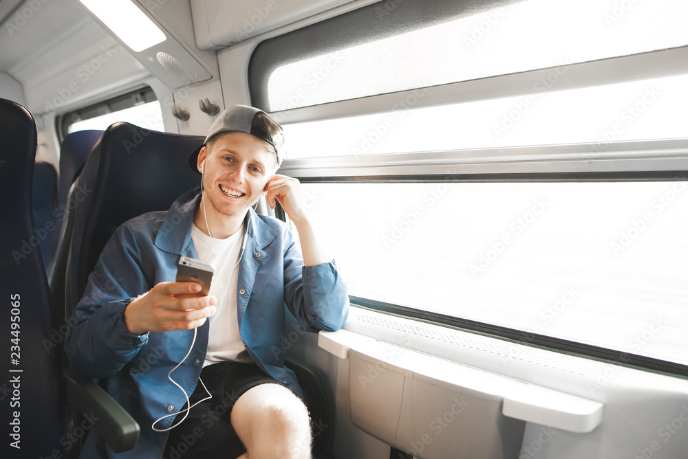 A person smiling and looking relaxed while sitting on a train