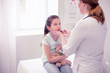 © zinkevych - Sore throat. Professional experienced family physician examining little girl having sore throat