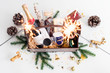 Sparklers and wooden basket with food for Christmas selebration. Happy winter holidays. Presents for Christmastime.