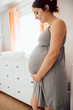 Pregnant Woman holds belly