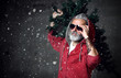 © Dmitry Lobanov - Fashionable modern Santa old man in red fashion hoodie and sunglasses Merry Christmas
