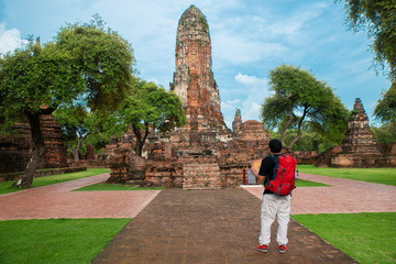 An Asian traveler is looking at the map to  plan to travel in Thailand. Destination,travelling and tourism concept.