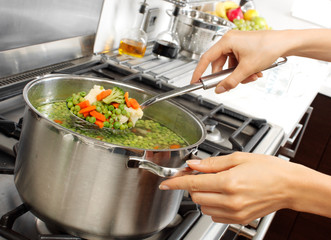 Canvas Print - WOMAN IN KITCHEN COOKING MIXED VEGETABLES