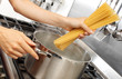 © cdkproductions - WOMAN IN KITCHEN COOKING SPAGHETTI