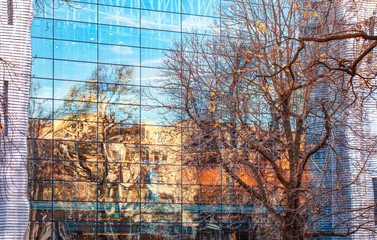   Glass reflections - buildings, blue sky and construction elements. Modern Facade. Poznan, Poland