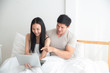 © Asada - Happy young Asian man and girl is purchasing an online product through the online shopping market. buying, selling, online , pre-order concept.