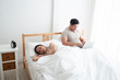 © Asada - An Asian man is working very happy in the bed room but his girlfriend is unhappy and unsatisfied about his manner because a man have not had a time for her. family,unhappy and divorce concept.