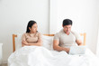 © Asada - An Asian man is working very happy in the bed room but his girlfriend is unhappy and unsatisfied about his manner because a man have not had a time for her. family,unhappy and divorce concept.
