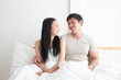 © Asada - Young lovely couple on the bed together with smiling and happiness. boyfriend,girlfriend, love and valentine concept