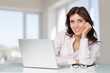 © BillionPhotos.com - Attractive young woman speaking phone and using laptop