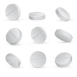 Round white medical pills in different positions