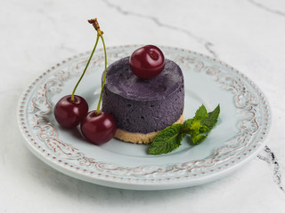 Poster - Round purple mini cheesecake with cherry berry