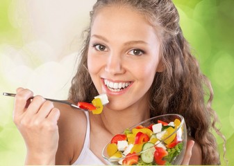 Wall Mural - Happy young woman drinking water isolated on white