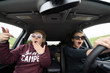 © MelissaMN - Two woman inside of a car looked shocked, scared and astounished as they are driving