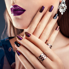 Beautiful woman with perfect make-up and manicure wearing jewellery