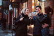 © Fxquadro - Cheerful friends making a toast with coffee near a cafe outside.