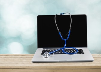 Wall Mural - Laptop diagnosis with  stethoscope  on background