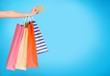 © BillionPhotos.com - Woman with shopping bags and card on mall background