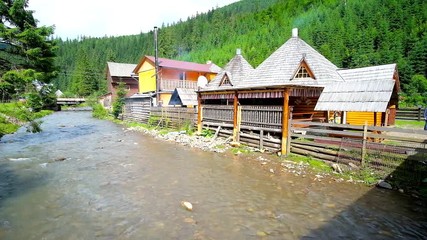 Poster - SYNEVYR, UKRAINE - JULY 1, 2018: Traditional Ukrainian restaurant in wooden house - koluba, located on the bank of Tereblya river in Synevyrska Polyana, Carpathian mountains, on July 1 in Synevyr. 