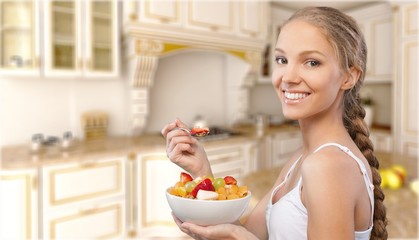 Canvas Print - Attracive young woman enjoying fruits on breakfast