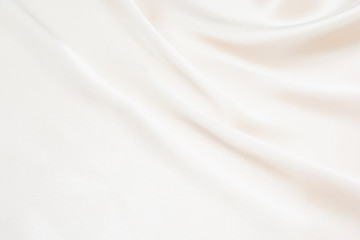 the texture of the satin fabric of beige color for the background