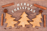 Fototapeta Panele - Gingerbreads in shape of christmas tree, inscription Merry Christmas and ingredients for baking
