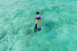 © mikumistock - Asian beautiful woman is snorkeling in the lagoon sea background.