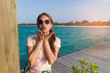 © mikumistock - Asian beautiful woman enjoyful traveling sea background.
