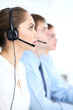 © rogerphoto - Call center operators at work. Focus at  business woman in headset
